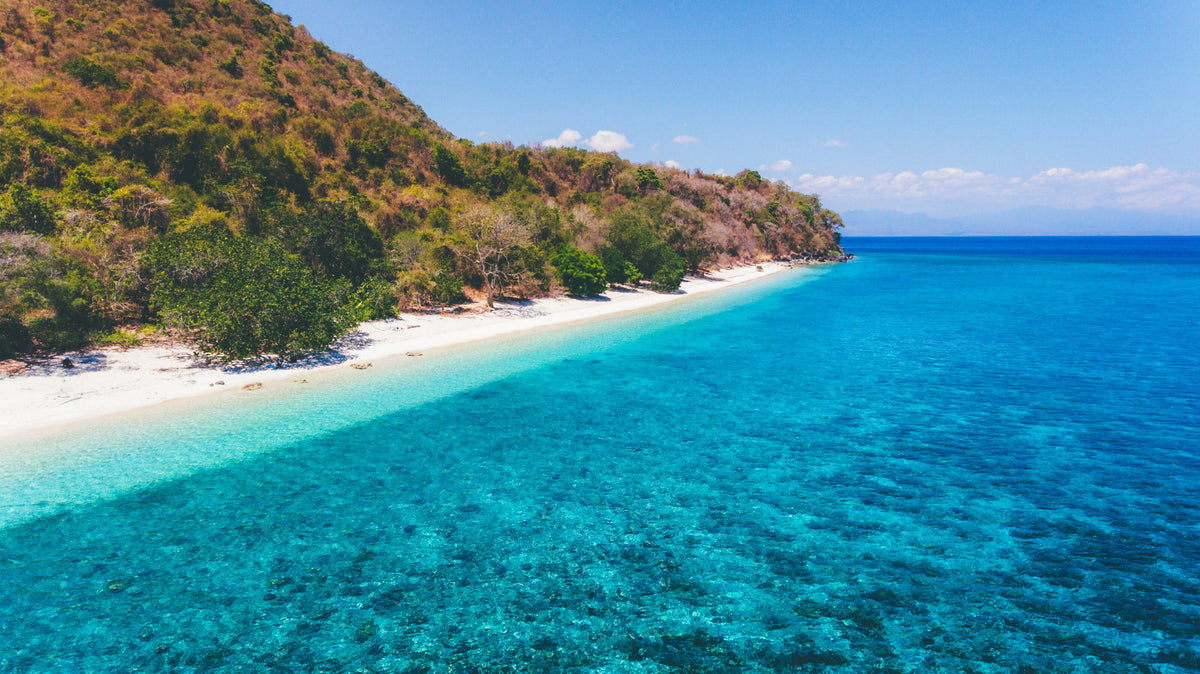 Aerial view of Poto Jarum Beach and shallow reef on Moyo Island, Sumbawa