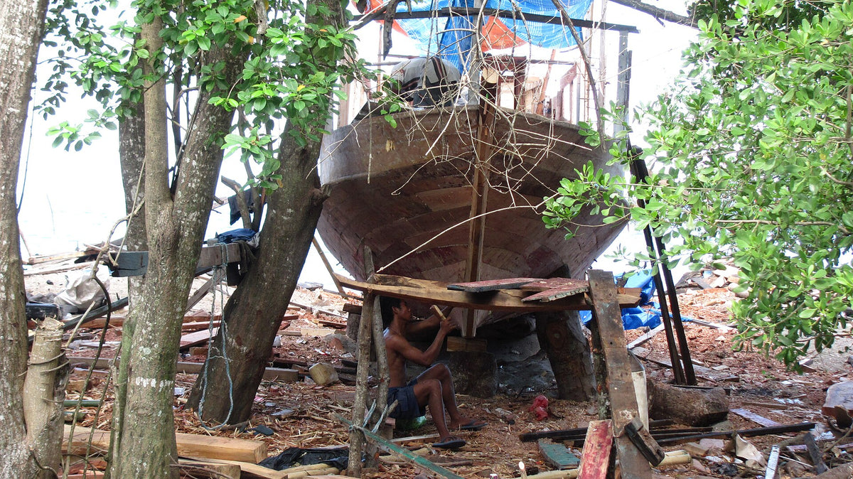 Traditional wooden boat under construction on Moyo Island