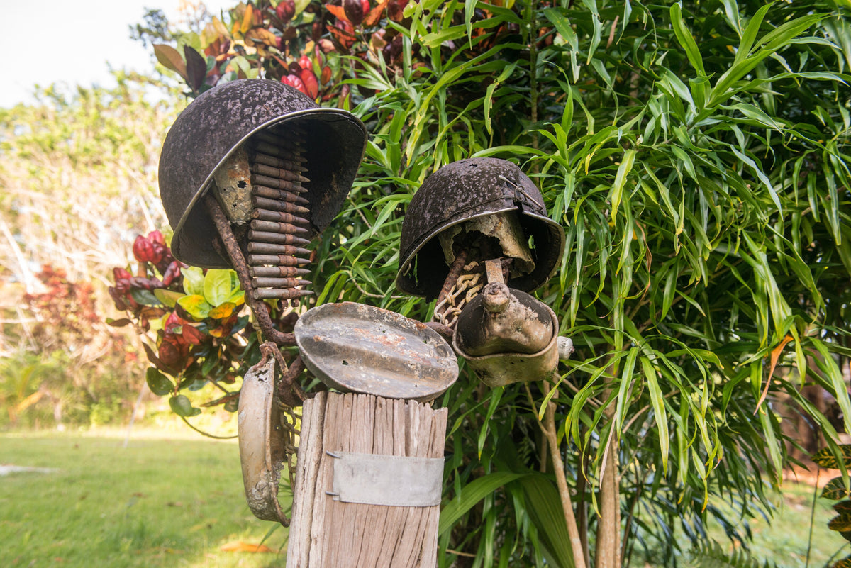 World War II helmets displayed outdoors in Munda, Solomon Islands