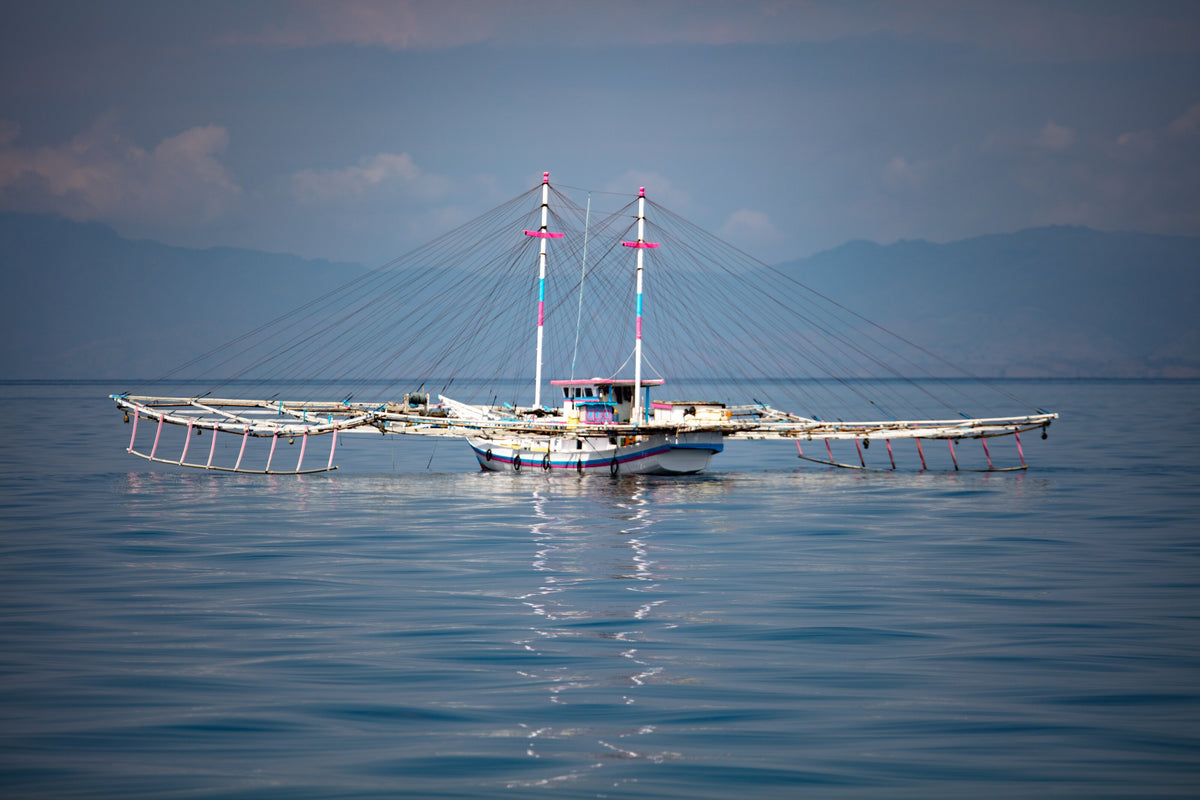 Traditional bagan fishing vessel on calm water in Saleh Bay, Sumbawa, Indonesia