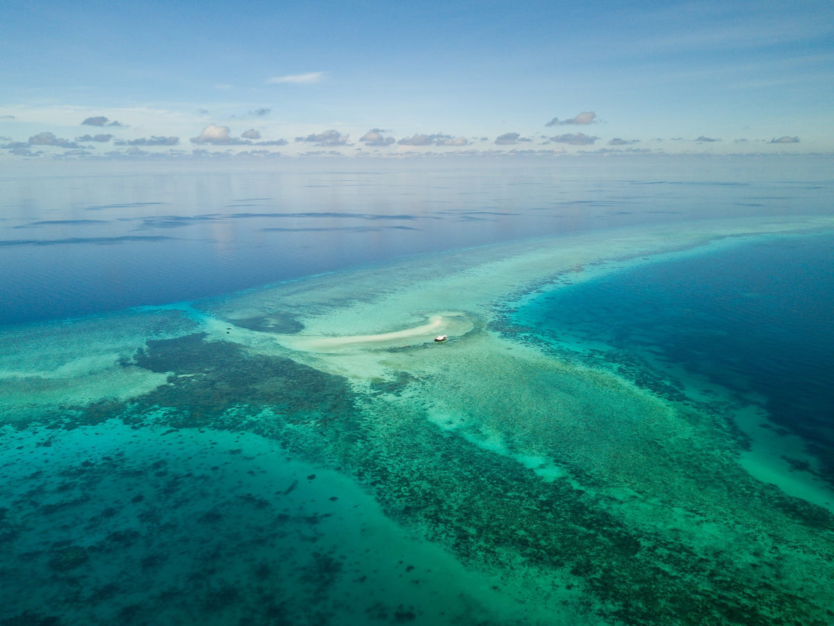 Aerial view of shallow reef and a sand cay at Tubbataha