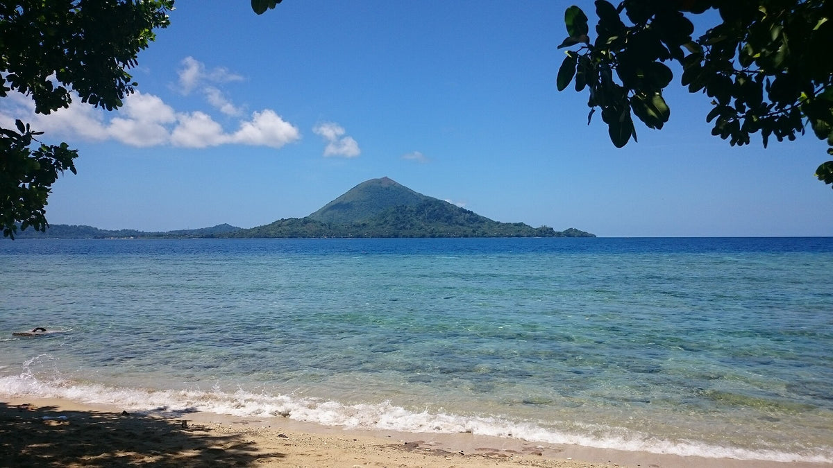 Gunung Api volcano seen across clear water from Pulau Pisang, Banda Islands