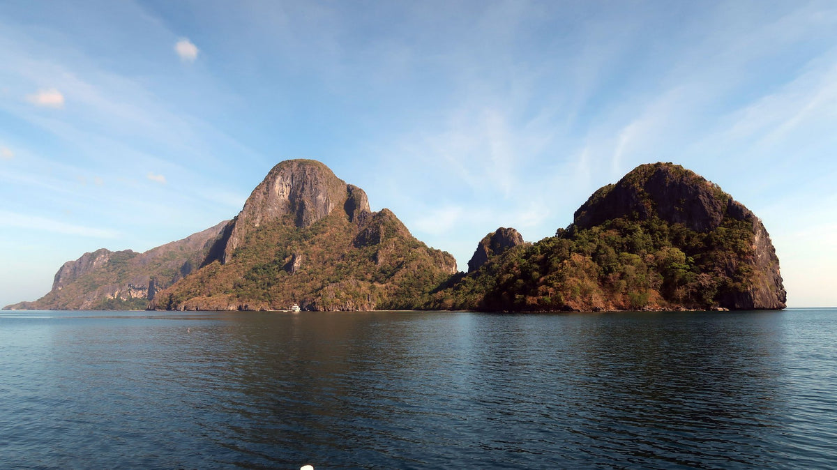 Limestone islands rising above the water in Bacuit Bay, El Nido