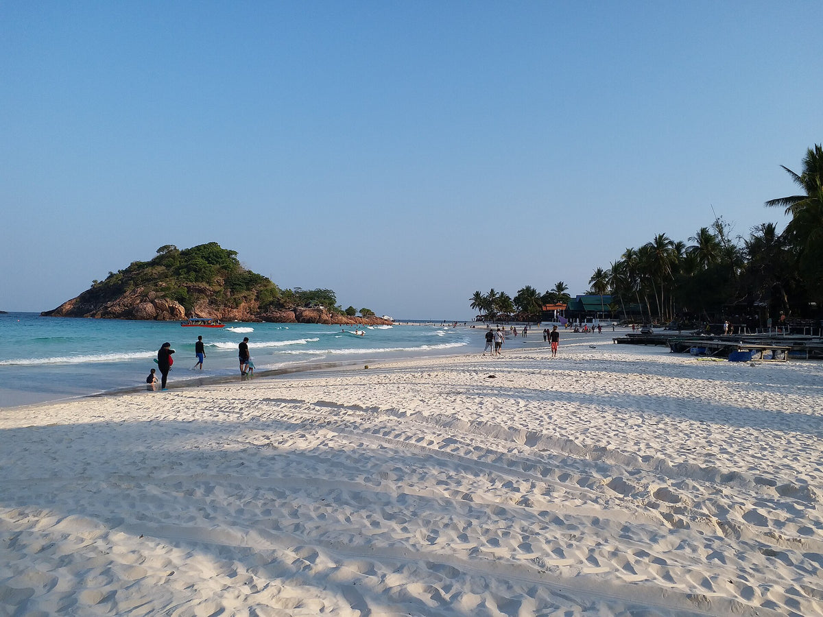 White sandy beach and a small rocky headland on Redang Island