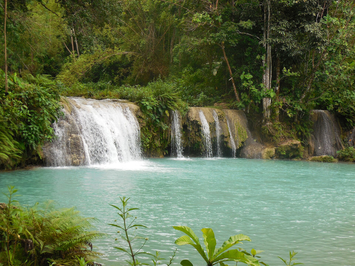 Cambugahay Falls cascading into a turquoise pool on Siquijor