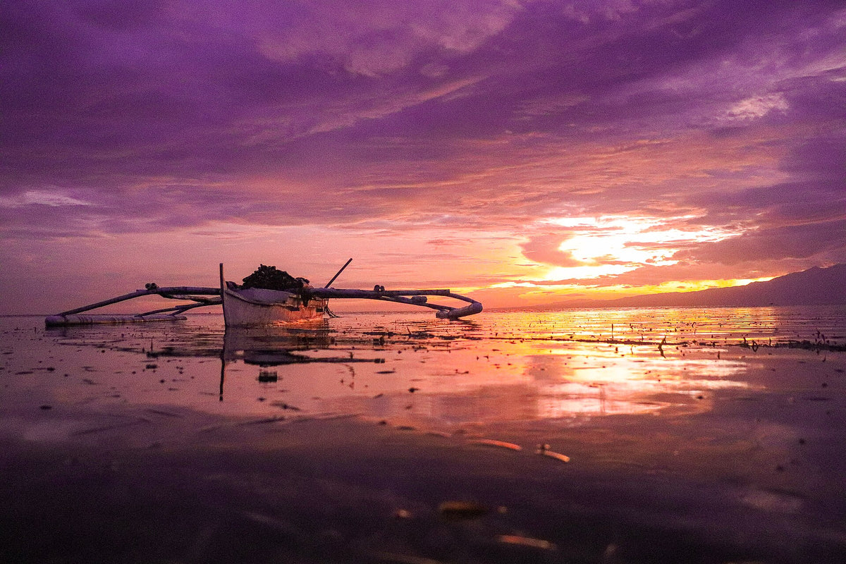 Outrigger boat at sunset in San Juan, Siquijor