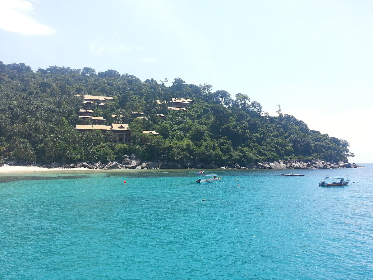 Boats in turquoise Salang bay on Tioman Island